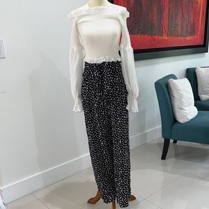 White off the shoulder top with black & white polka-dotted high waisted pants